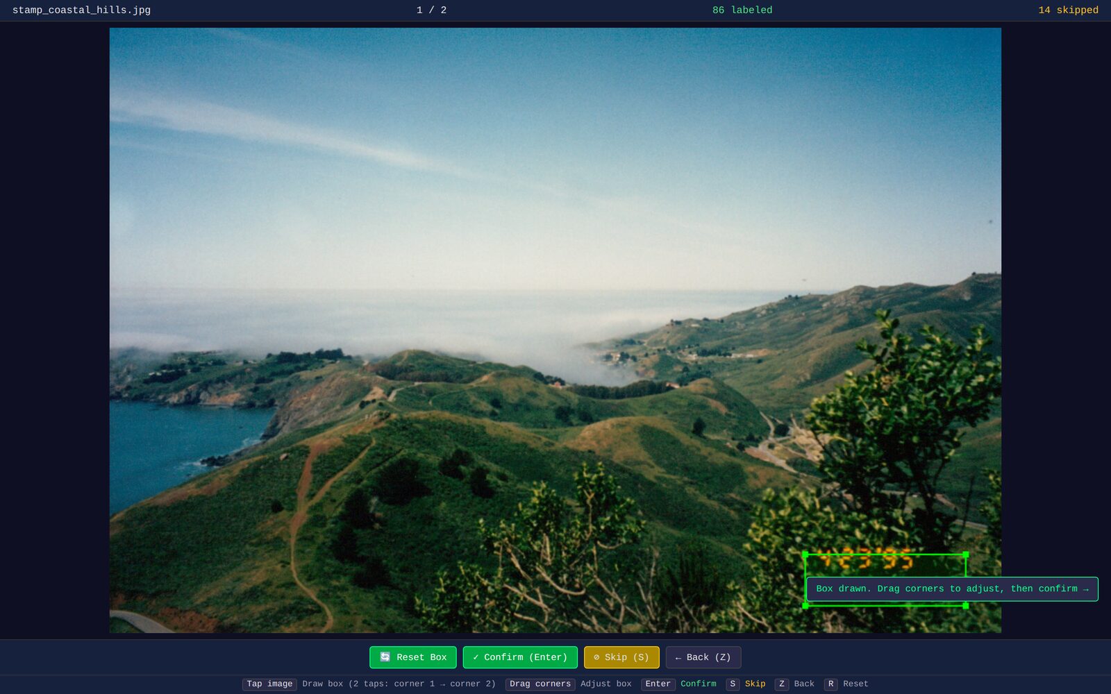 Screenshot of the browser-based annotation UI: a scanned photo of a bridge over a canyon fills the viewport, a green bounding box has just been dragged in the bottom-right corner, and the header shows the image filename, a 101/7456 progress counter, and labeled/skipped tallies. A button bar at the bottom lists Reset Box, Confirm, Skip, and Back, and a row of keyboard hints sits underneath.